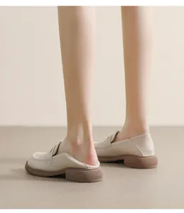 Detail of beige platform loafers with a flexible heel for two-way wearable comfort