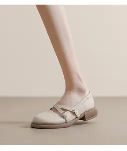 Detail of off-white Mary Jane shoes with double straps and durable thick brown rubber soles