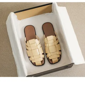 Detail of woven beige leather flat sandals with brown leather insoles in premium box
