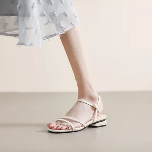 Elegantes sandalias planas beige minimalistas con correas finas y tacón dorado