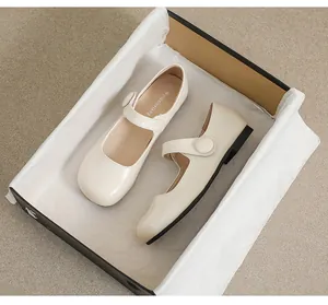 Unboxing of cream Mary Jane flats featuring a single strap with a large round button detail