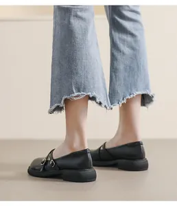 Detail of black platform Mary Jane shoes with double criss-cross straps and matte leather