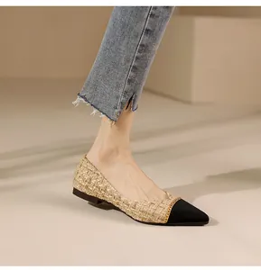 Detail of tweed pointed-toe flats with gold chain accent and black contrast toe cap