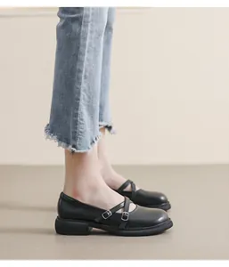 Detail view of black matte Mary Jane shoes with double straps and thick rubber sole