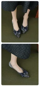 Macro detail of pointed flats featuring black silver sequins and a large velvet bow decoration