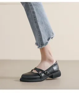 Close-up of black leather Mary Jane shoes with double buckle straps and platform soles