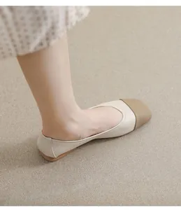 Close-up of square toe flats featuring beige leather and brown woven texture detail