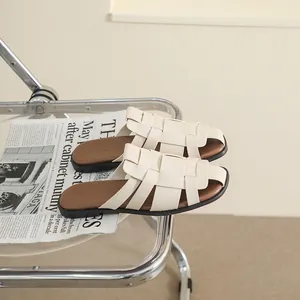 Retro cream woven flat sandals on an aesthetic chair with a classic summer vibe