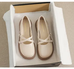 Detailed top view of beige platform Mary Jane shoes with cross straps and metal buckles