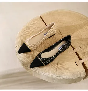 Top view of pointed-toe flats in tweed fabric with elegant gold chain decoration