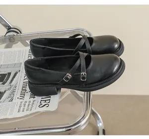 Detail of black matte Mary Jane shoes with double buckle straps and chunky platform sole