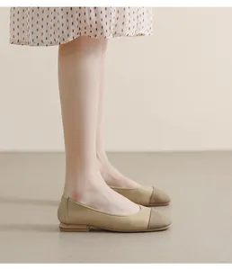 Detail of square toe flat shoes with beige leather and dark contrast toe cap design