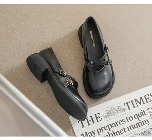 Close-up of retro black Mary Jane shoes with double straps and white stitching details
