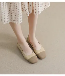 Close-up of beige and brown two-tone square toe flat shoes with textured knit detail