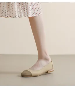 Close-up of two-tone ballet flats with lychee texture leather and woven toe detail