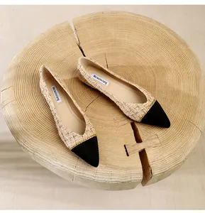 Detail shot of tweed pointed toe flats with black contrast toe and gold chain trim