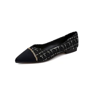 Macro detail of pointed-toe flat shoes featuring black gold tweed and chain link