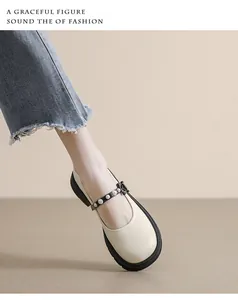 Close-up of Mary Jane shoe featuring pearl buckle and black floral bow detail