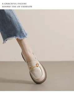 Detail of cream platform loafers with golden horsebit buckle and round toe design