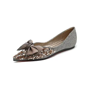 Elegant pointed toe flats with silver glitter finish and rhinestone bow decoration
