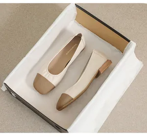 Detailed shot of two-tone square toe flat shoes with wood texture low heel in a box