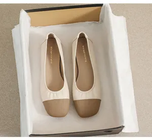 Detailed top view of square toe flat shoes with contrast brown tip and perforated texture