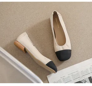Detail view of square toe flat shoes with beige and black contrast color design