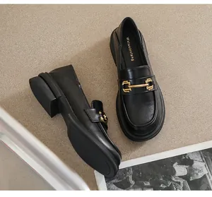 Detailed top view of black leather loafers with gold horsebit and vintage British style
