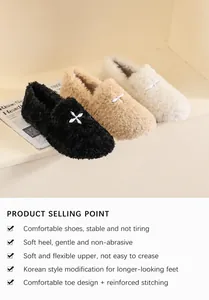 Close-up detail of plush faux fur upper and decorative cross hardware on stylish flat mules