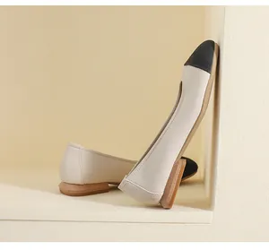 Close-up of two-tone flat shoes with lychee texture leather and wood grain heels