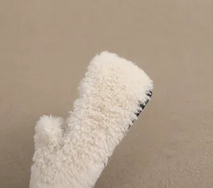 Detail of 1.0cm flat heel design on beige plush faux fur winter slip-on shoes