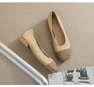 Detail of square toe flat shoe with cream leather and wood grain textured heel