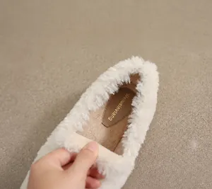 Detail of plush faux fur lining and breathable microfiber insole of winter flat shoes