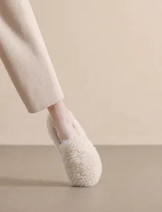 On-foot view of plush beige faux lamb wool loafers with cozy round-toe and flat soft sole