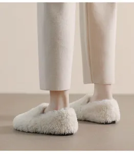 Detailed view of women's cream faux fur loafers with soft soles and plush texture