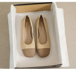 Detail of square toe flat shoes with beige and dark brown contrast and perforated texture