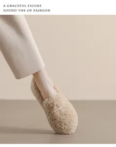Detail of soft plush ballet flats featuring a cross metal buckle on the light brown fur