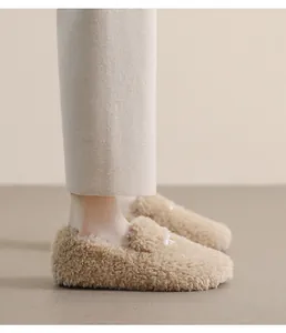 Detail of camel plush loafers showing soft faux fur texture and round toe design