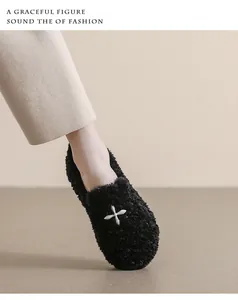 Detail of plush black loafers featuring stylish silver star buckles and fuzzy texture