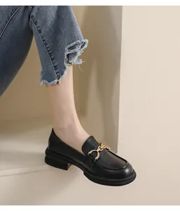 Gros plan de mocassins noirs à plateforme avec boucle mors dorée élégante