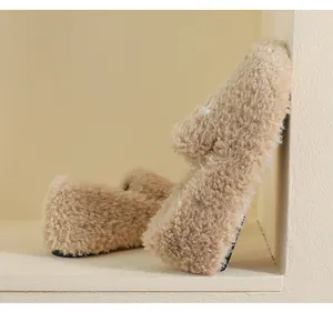 Close-up of soft beige faux fur loafers with fluffy texture and thin rubber soles