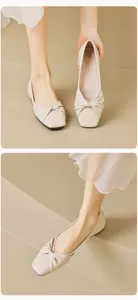 Detail of beige square-toe flats with stylish twist-knot design and soft leather texture