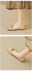 Detail of square toe flat shoes with cross knot design and soft beige leather finish