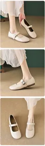 Detail view of beige Mary Jane flats featuring a round toe design and metal buckle strap