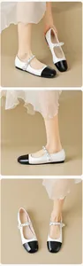 Detail of round toe Mary Jane flats with chic metal chain and elegant pearl accent