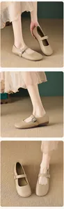 Detail view of khaki Mary Jane flat shoes with silver buckle and matte leather texture