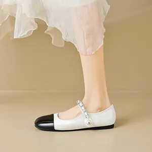 French style two-tone patent leather Mary Jane flats with pearls and chain detail