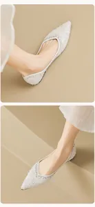 Detail of white pointed flat shoes with sparkling sequins and crystal trim for weddings