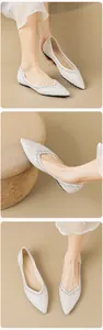 Macro shot of white sparkling rhinestones on pointy-toe flat shoes for women