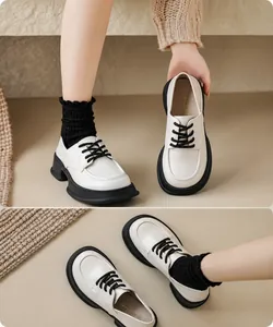Detail view of beige platform Derby shoes with black laces and thick soles in classic style